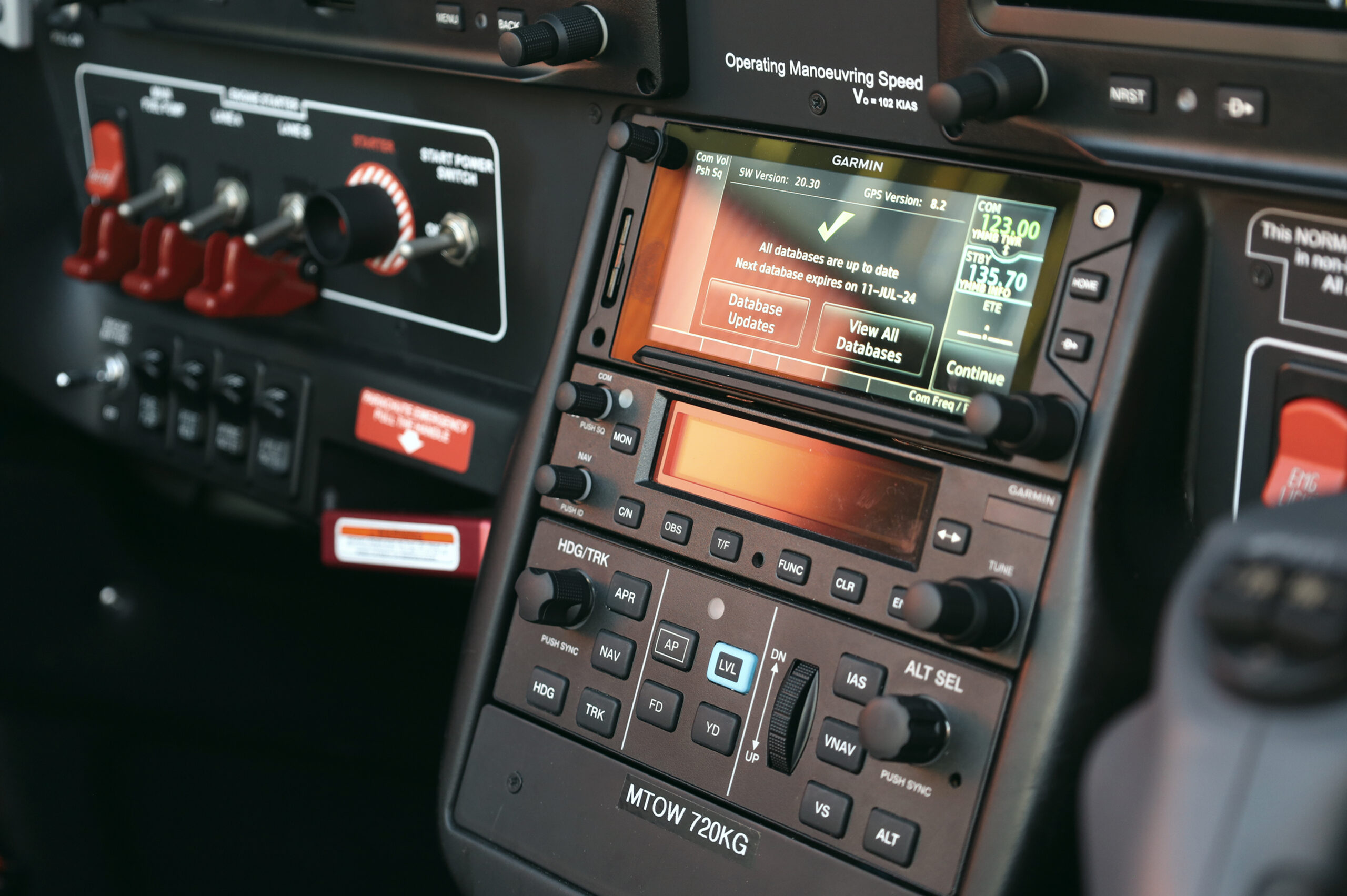 Close-up of a modern aircraft cockpit control panel showing navigation and communication systems during pre-flight setup.