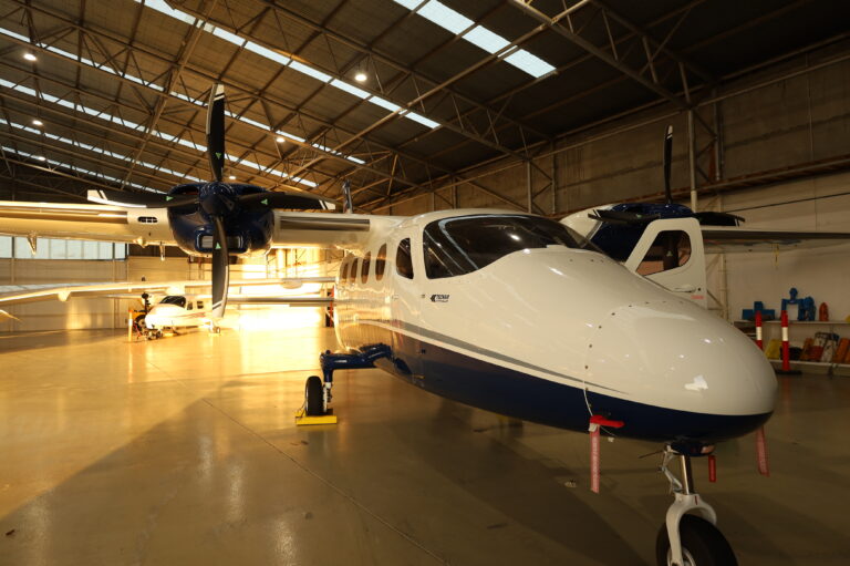 Twin-engine aircraft inside a hangar used for advanced instrument rating (IR) training and multi-engine endorsements in commercial flight programs.